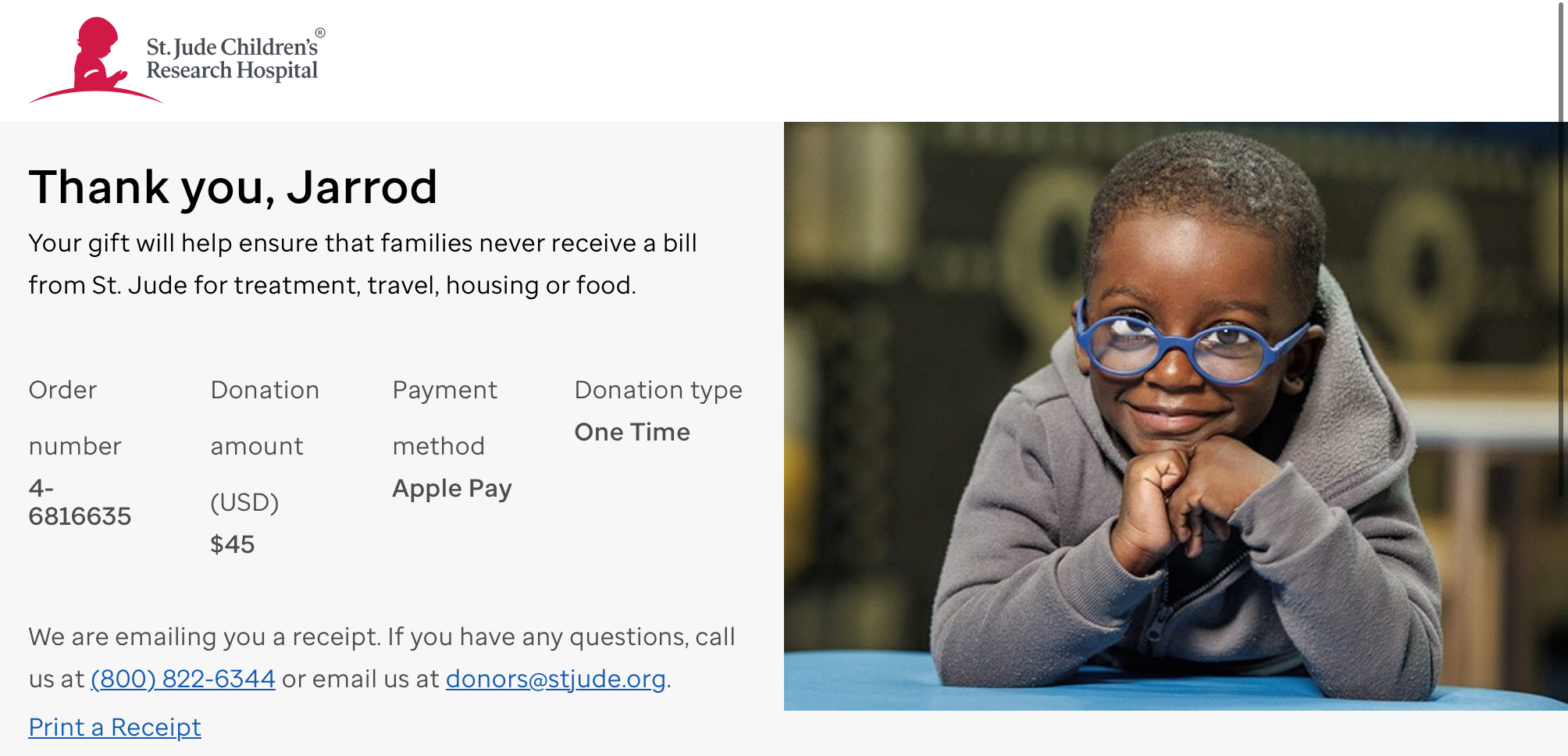 Child wearing blue glasses smiles while resting on folded hands at a table. Text expresses gratitude for a $45 one-time donation to St. Jude via Apple Pay. Contact and receipt information included.